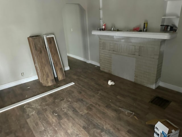 interior space featuring a fireplace and dark hardwood / wood-style floors