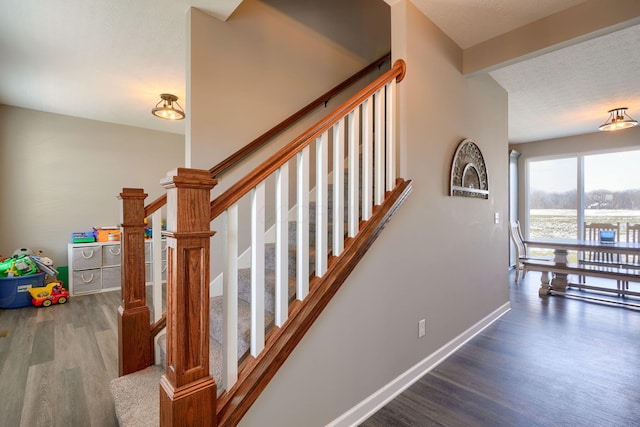 stairs with hardwood / wood-style floors