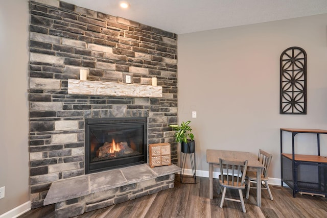 living room with hardwood / wood-style flooring and a fireplace