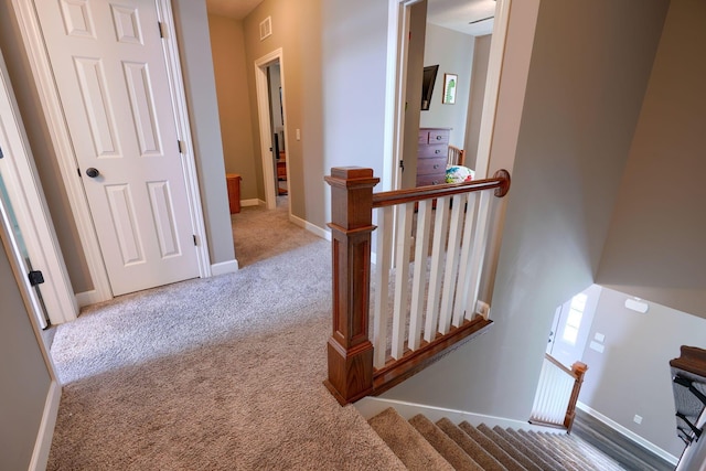 hall featuring carpet flooring