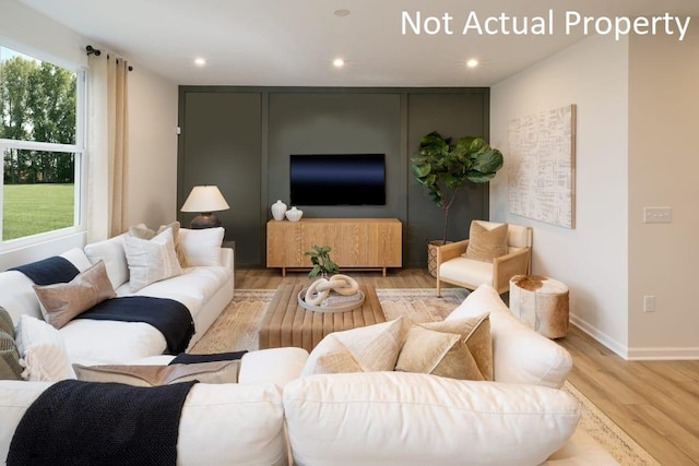 living area featuring baseboards, wood finished floors, and recessed lighting