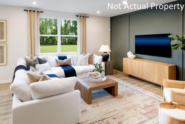 living area with light wood-type flooring, baseboards, and recessed lighting