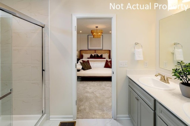 full bathroom featuring double vanity, connected bathroom, marble finish floor, a shower stall, and a sink