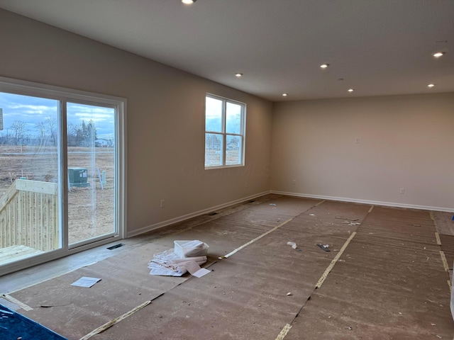 unfurnished room with recessed lighting, visible vents, and baseboards