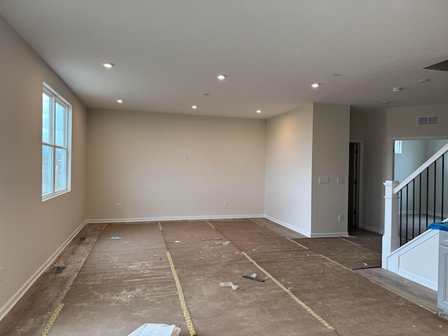 spare room featuring recessed lighting, visible vents, stairway, and baseboards