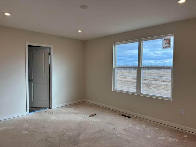 unfurnished room with baseboards and recessed lighting