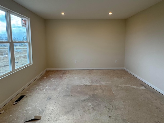 spare room with a wealth of natural light, baseboards, and recessed lighting