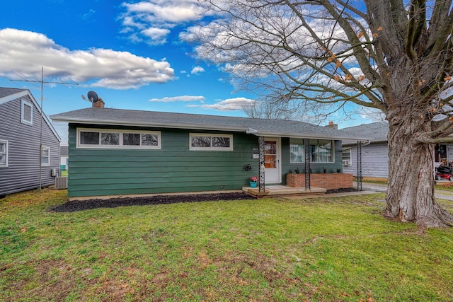 ranch-style house with central AC unit and a front lawn