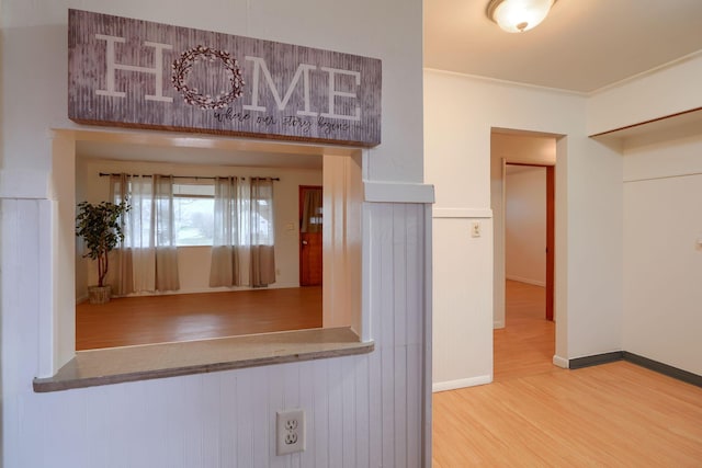 kitchen featuring hardwood / wood-style floors and crown molding