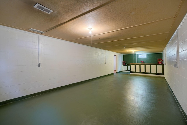 basement featuring a textured ceiling