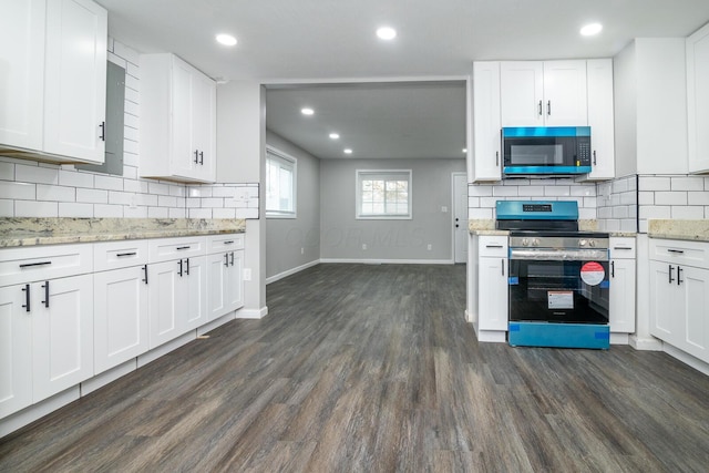 kitchen with white cabinets, dark hardwood / wood-style flooring, stainless steel electric stove, and backsplash