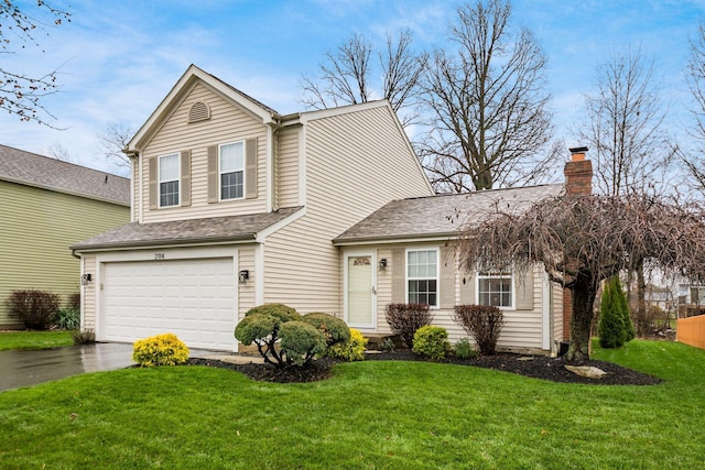 view of front of home with a garage and a front yard