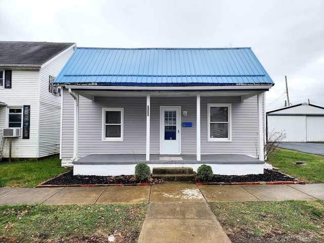 view of front of property with cooling unit and covered porch