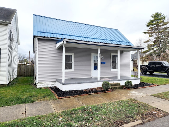 bungalow with a porch and a front yard