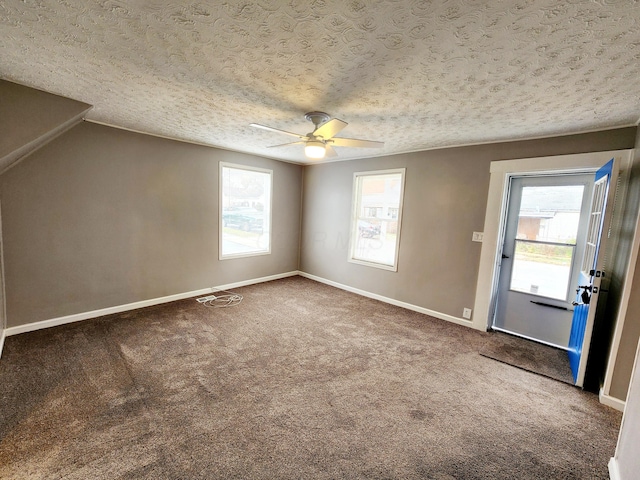 spare room with carpet flooring, ceiling fan, and a textured ceiling