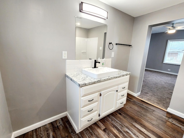 bathroom with wood-type flooring, vanity, and ceiling fan