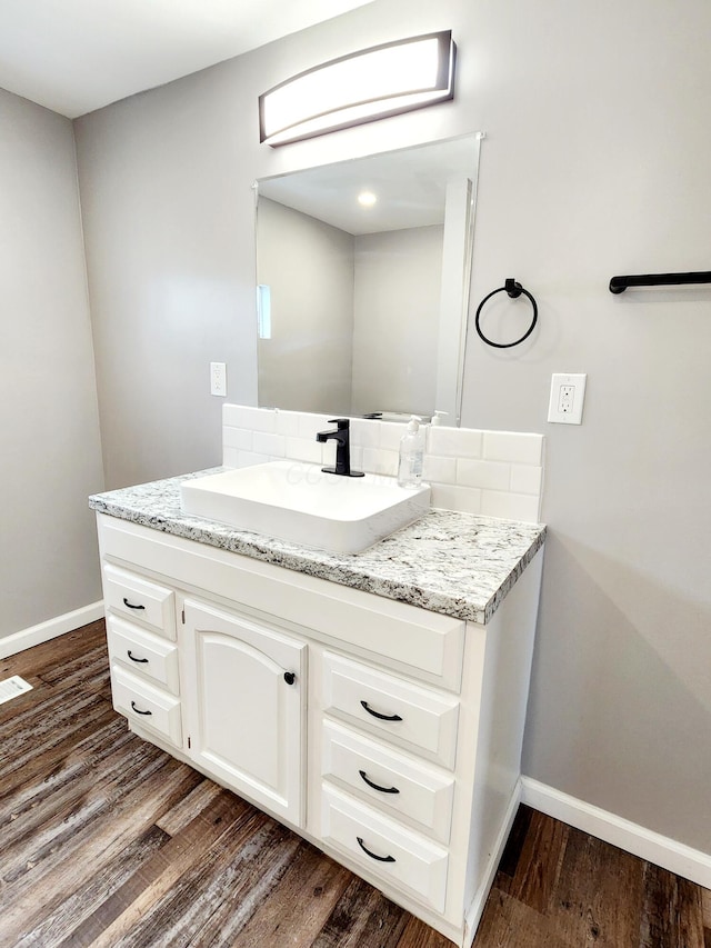 bathroom featuring hardwood / wood-style flooring and vanity