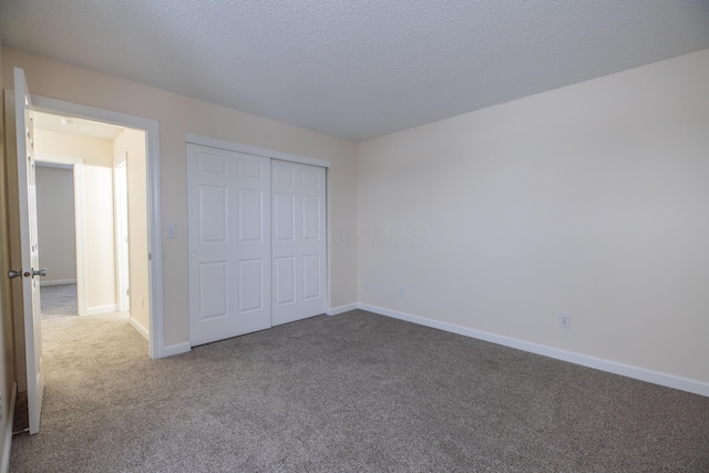 unfurnished bedroom with a closet, a textured ceiling, and carpet floors