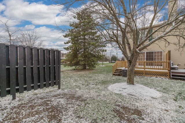 yard covered in snow with a wooden deck