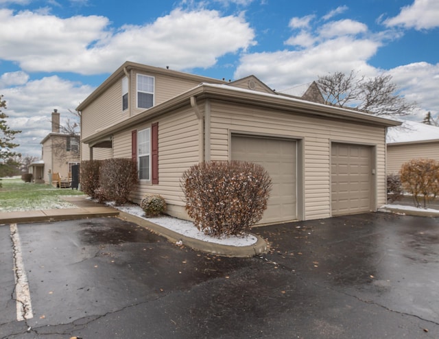 view of side of home with a garage