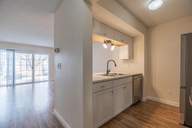 kitchen with sink, stainless steel appliances, white cabinets, and dark hardwood / wood-style flooring