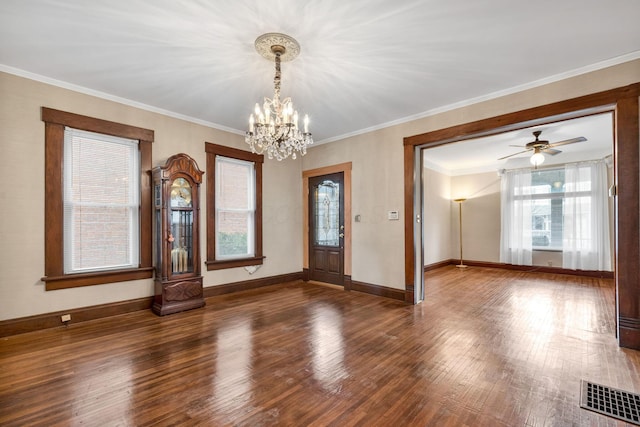 interior space featuring dark hardwood / wood-style flooring, ceiling fan with notable chandelier, and ornamental molding