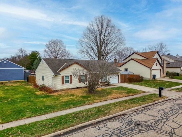 ranch-style house featuring a garage and a front lawn