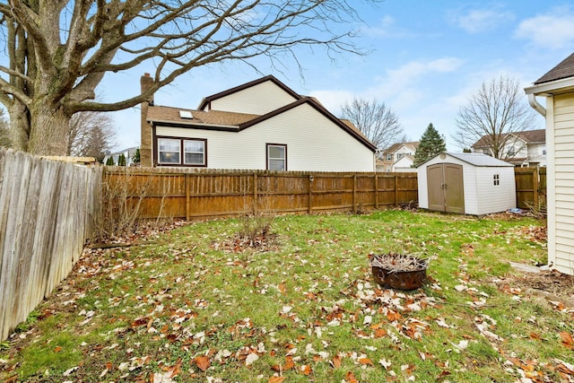 view of yard featuring a storage unit and an outdoor fire pit