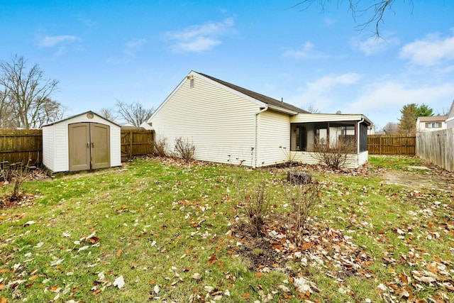 view of home's exterior with a sunroom, a shed, and a yard