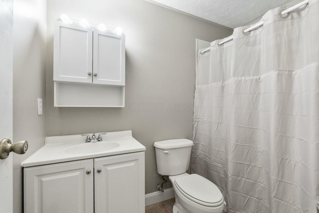 bathroom with a shower with curtain, vanity, a textured ceiling, hardwood / wood-style flooring, and toilet