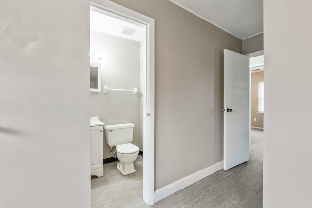 bathroom featuring wood-type flooring and toilet