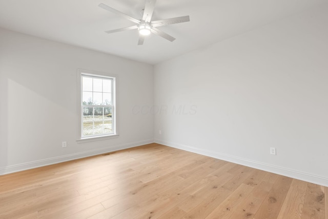 unfurnished room with baseboards, ceiling fan, and light wood-style floors