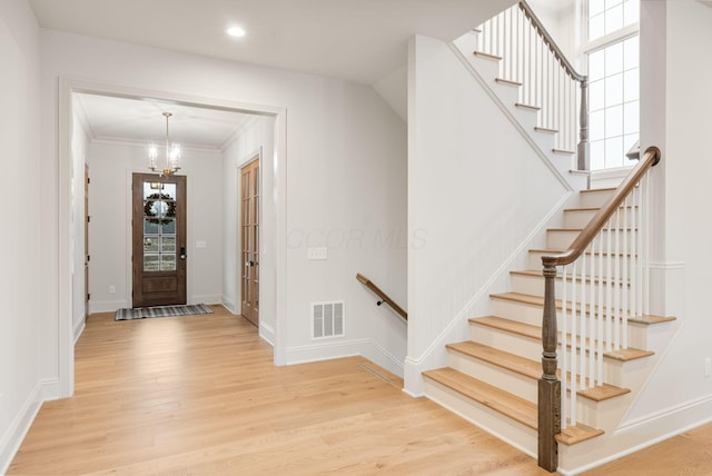 entrance foyer with light wood-style flooring, recessed lighting, visible vents, baseboards, and crown molding