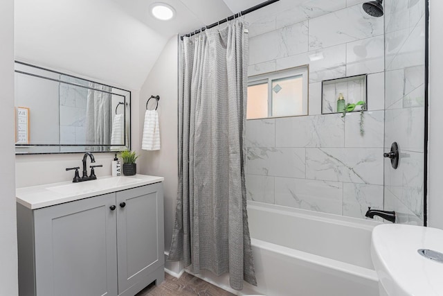 bathroom with vanity, shower / tub combo with curtain, and lofted ceiling