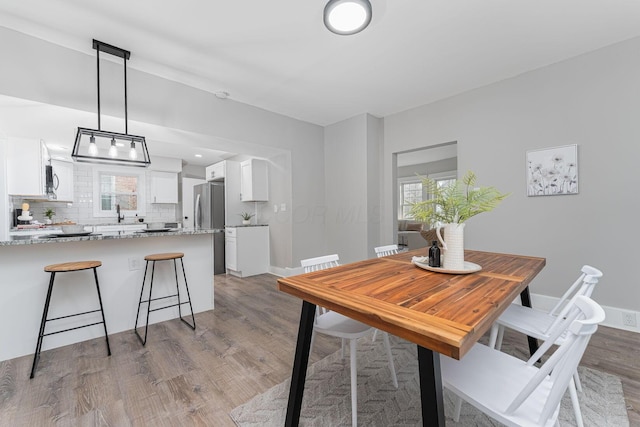 dining space featuring light wood-type flooring