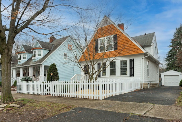 view of front facade featuring a garage and an outdoor structure