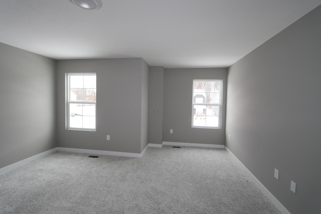 empty room featuring light carpet