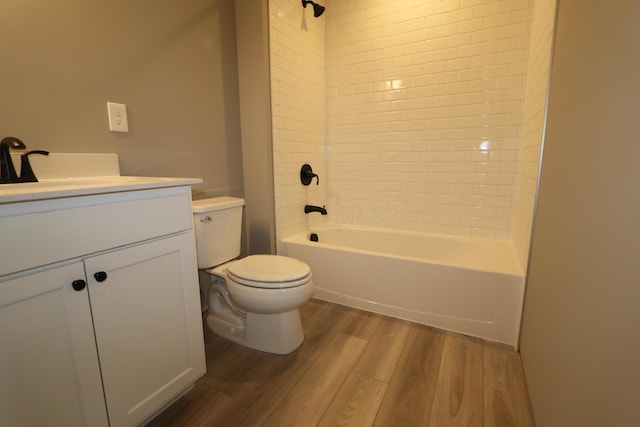 full bathroom featuring vanity, toilet, tiled shower / bath combo, and hardwood / wood-style flooring