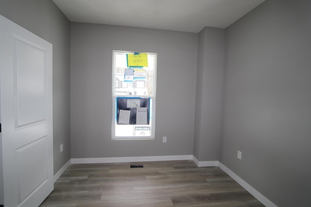 empty room with hardwood / wood-style flooring