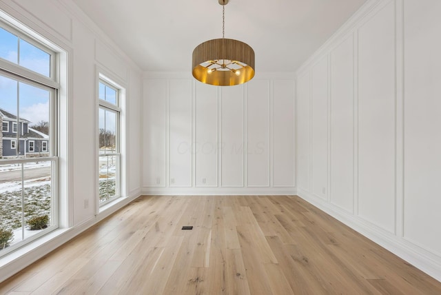 unfurnished dining area with light hardwood / wood-style flooring