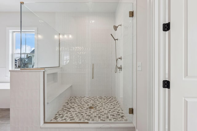 bathroom with tile patterned floors and an enclosed shower