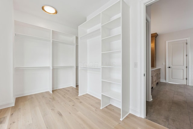 walk in closet featuring light hardwood / wood-style flooring