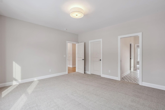 unfurnished bedroom featuring light carpet