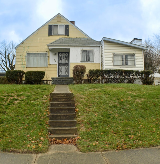 bungalow-style home featuring a front lawn