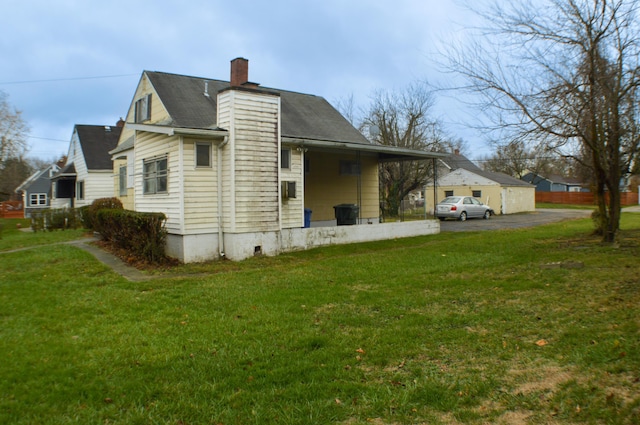 rear view of house featuring a yard