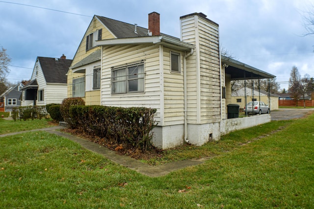 view of side of home featuring a lawn