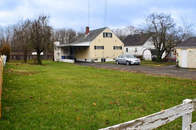 view of side of home featuring a lawn