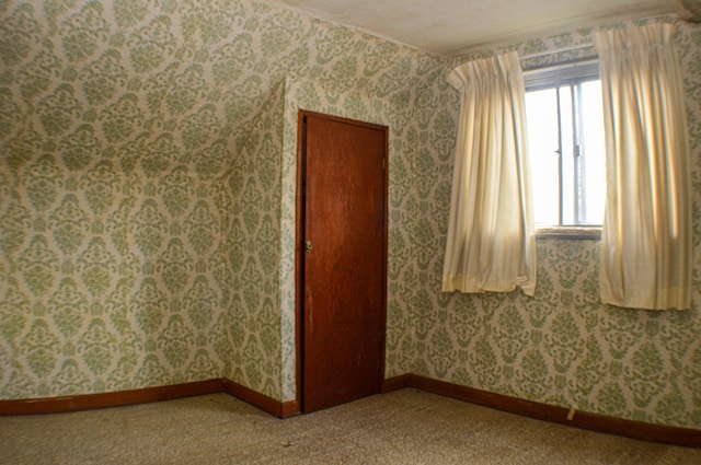 unfurnished room with carpet floors and a textured ceiling