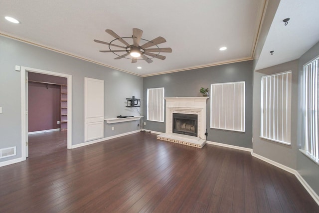 unfurnished living room with visible vents, baseboards, wood-type flooring, ceiling fan, and a brick fireplace