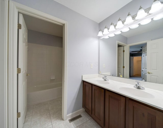 bathroom with double vanity, visible vents, a sink, and tile patterned floors